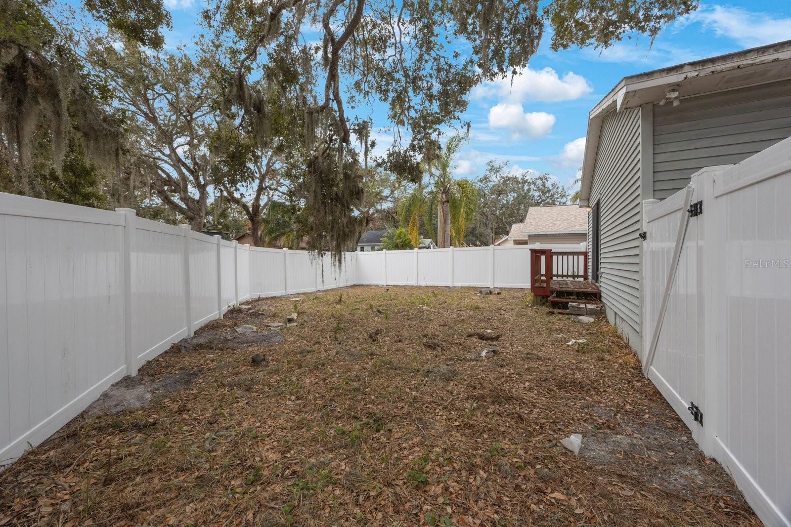 Fenced in backyard with the brand-new fence!