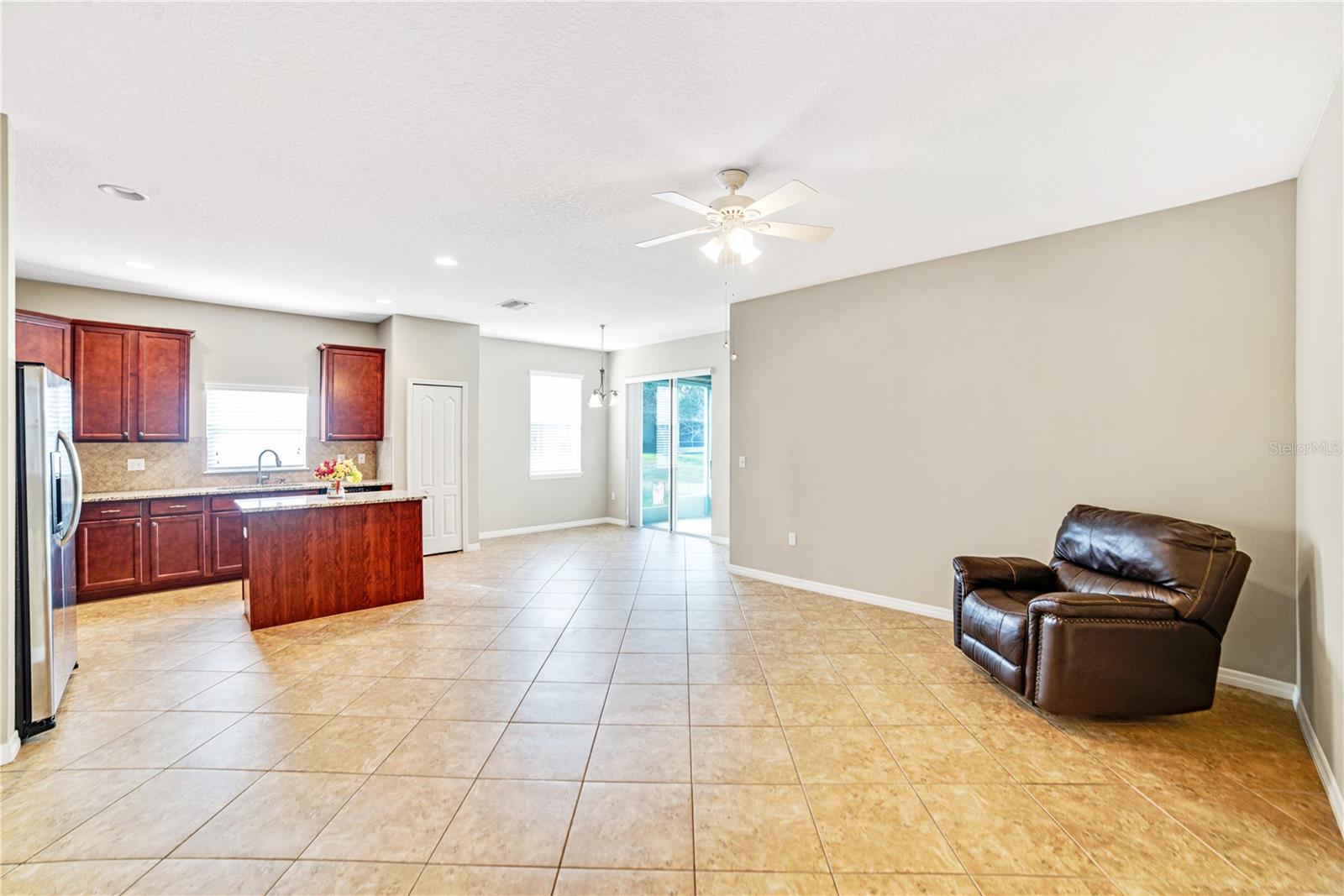 VIEW FROM FAMILY ROOM LOOKING AT ADJOINING KITCHEN AND BREAKFAST AREA