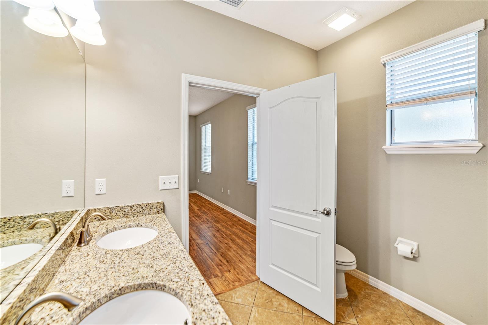 ENSUITE FEATURES DUAL SINKS WITH GRANITE COUNTERTOP