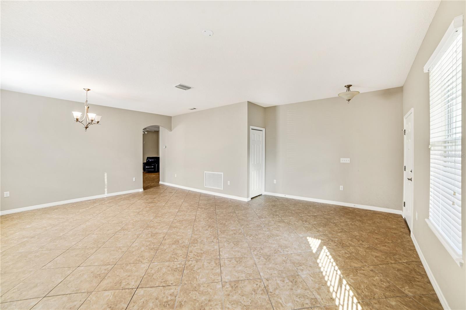 ENTRY TO FOYER AREA AND GREAAT ROOM.  COAT OR STORAGE CLOSET IS AN EXTRA BONUS