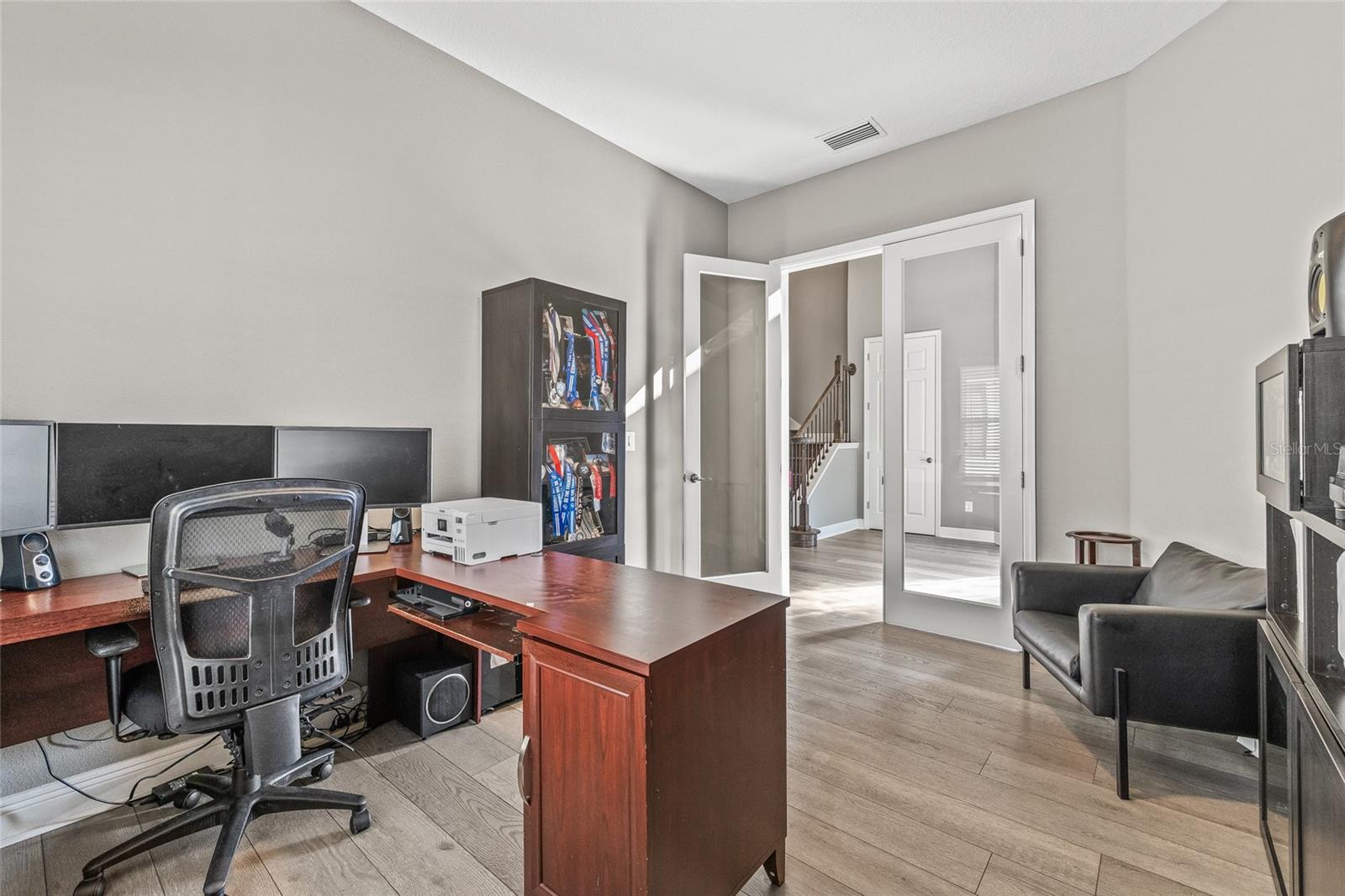 Office with french doors at the front of the home.