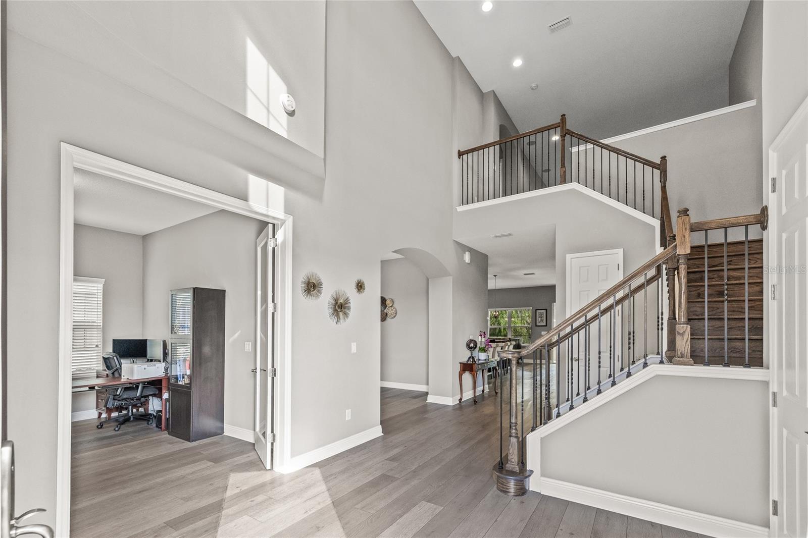 Entry way with grand staircase and front office with french doors