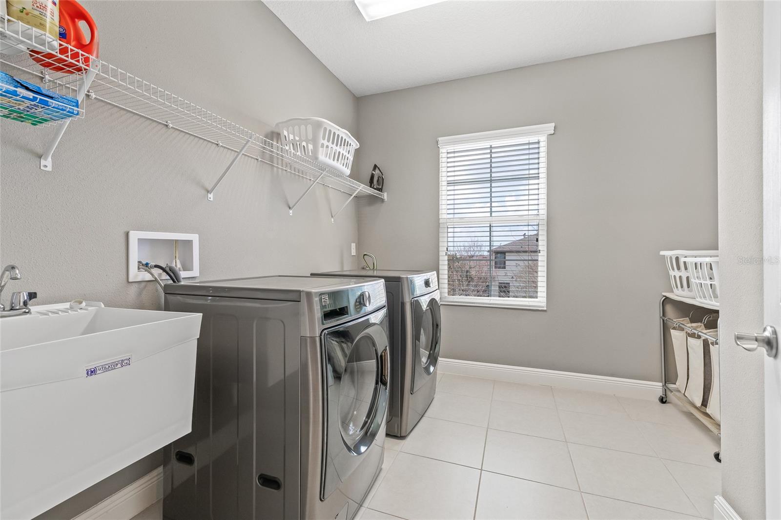 Laundry room on the 2nd floor with slop sink and storage