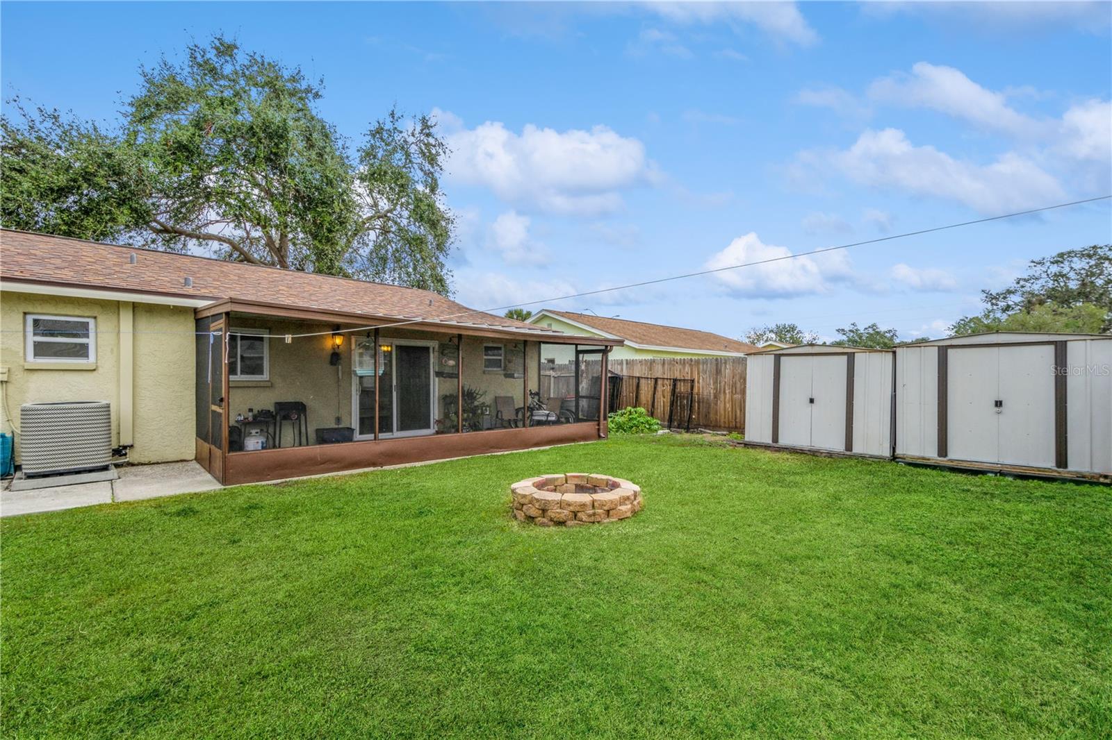 spacious yard with firepit and storage shed