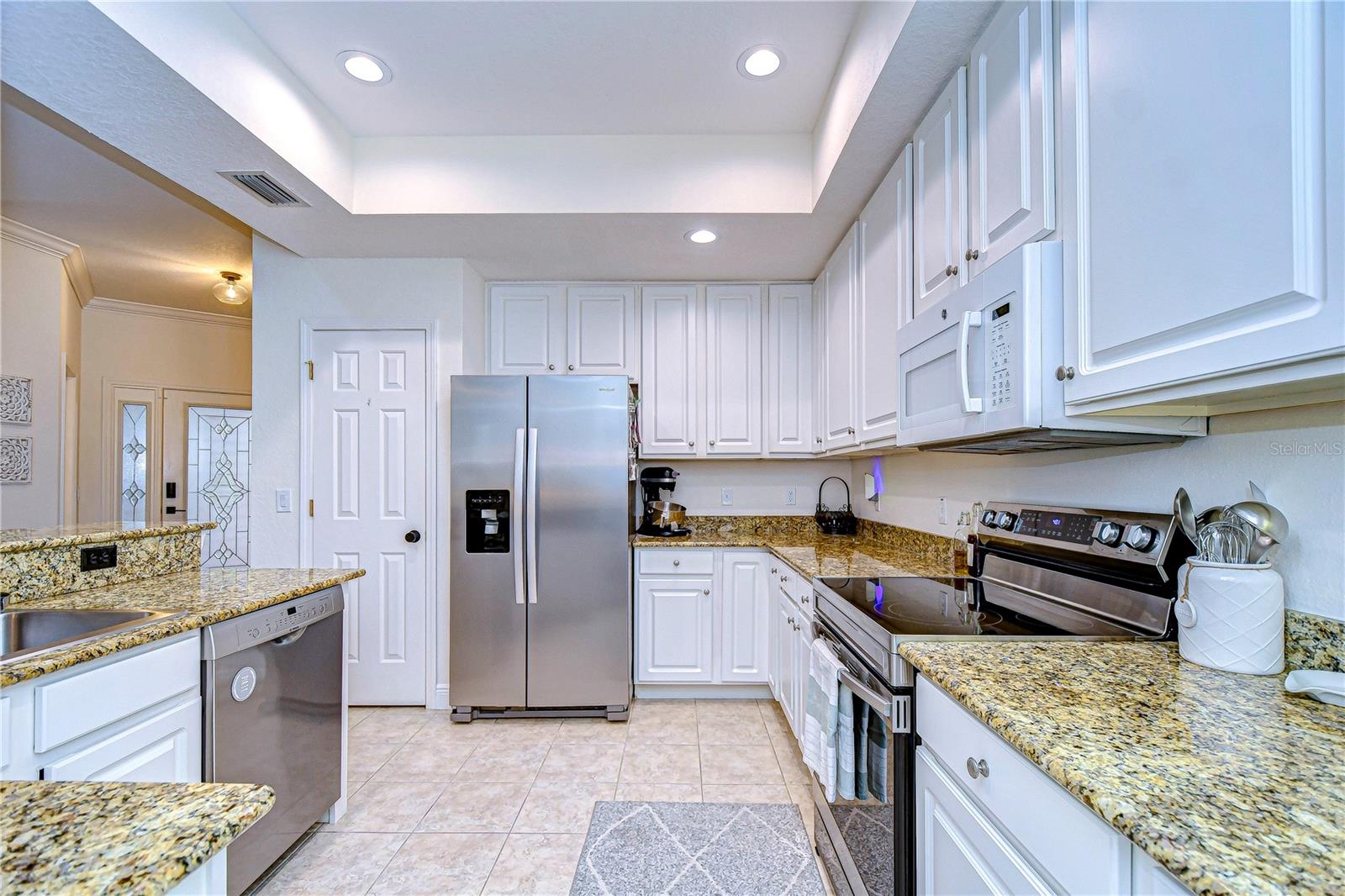 Granite counter tops and ample cabinetry space make storage a breeze.