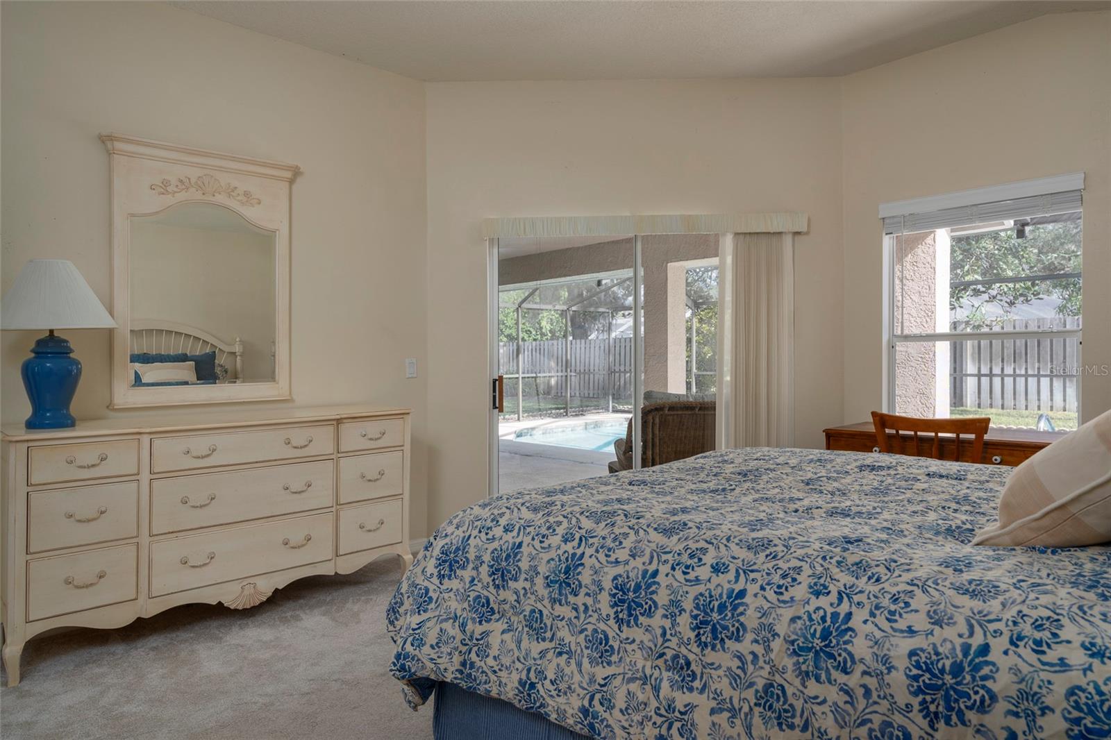 Primary Bedroom with pool entrance and view