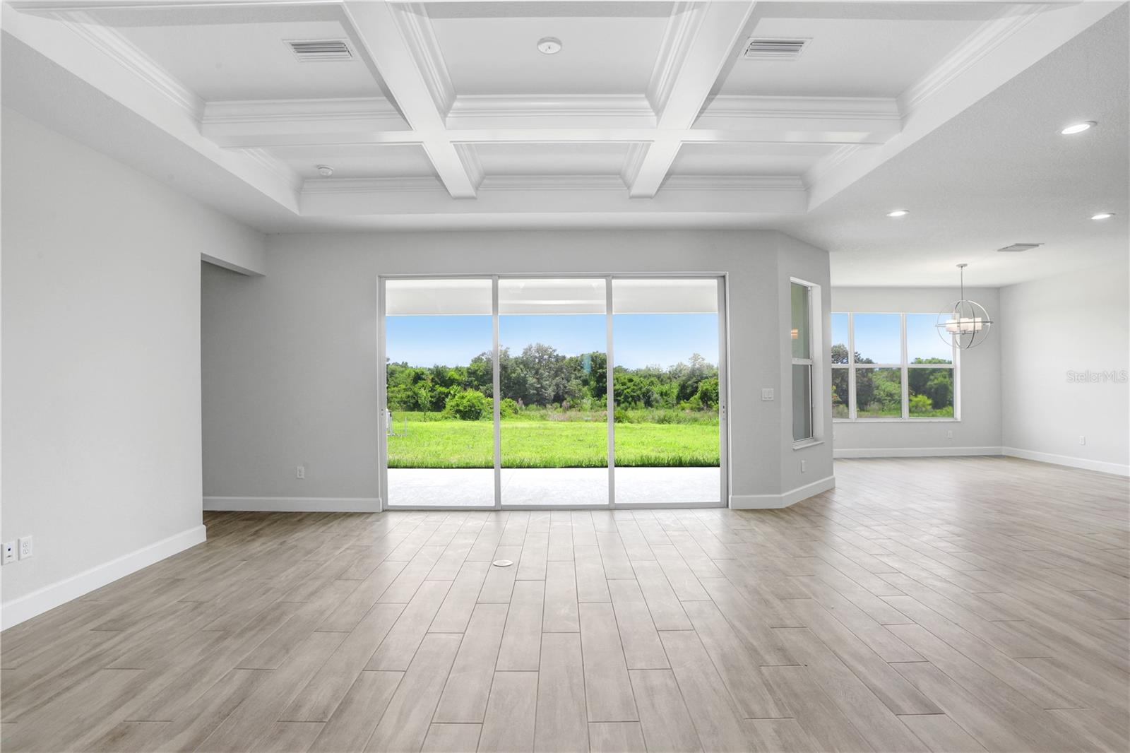 Great Room with Coffered Ceiling Overlooking Conservation Views