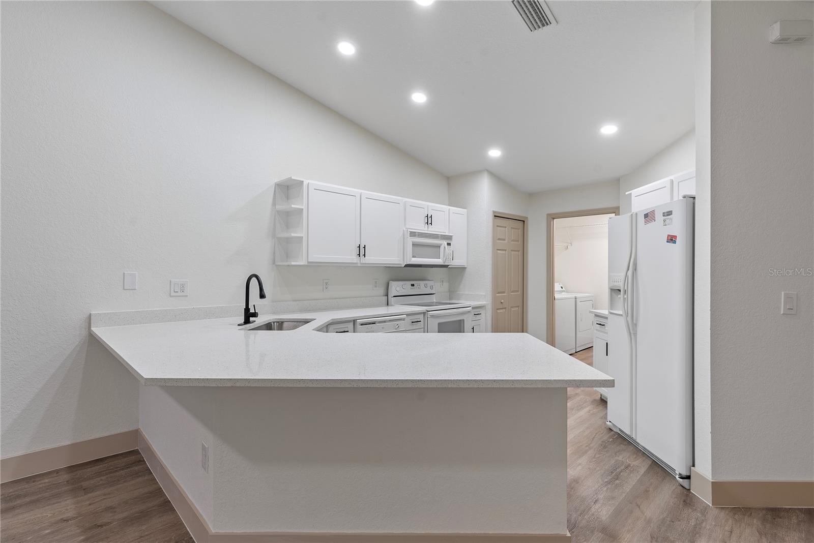 Kitchen With White Quartz Countertops.