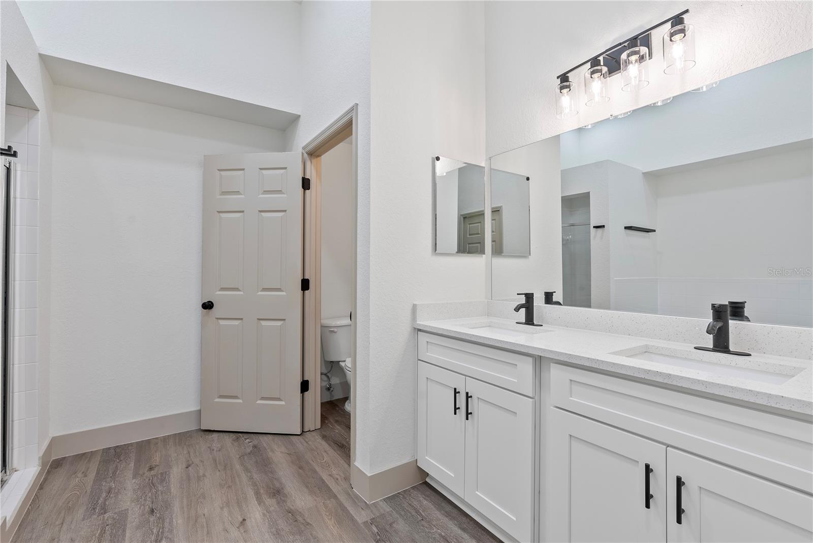 Master Bathroom With White Quartz Countertops.