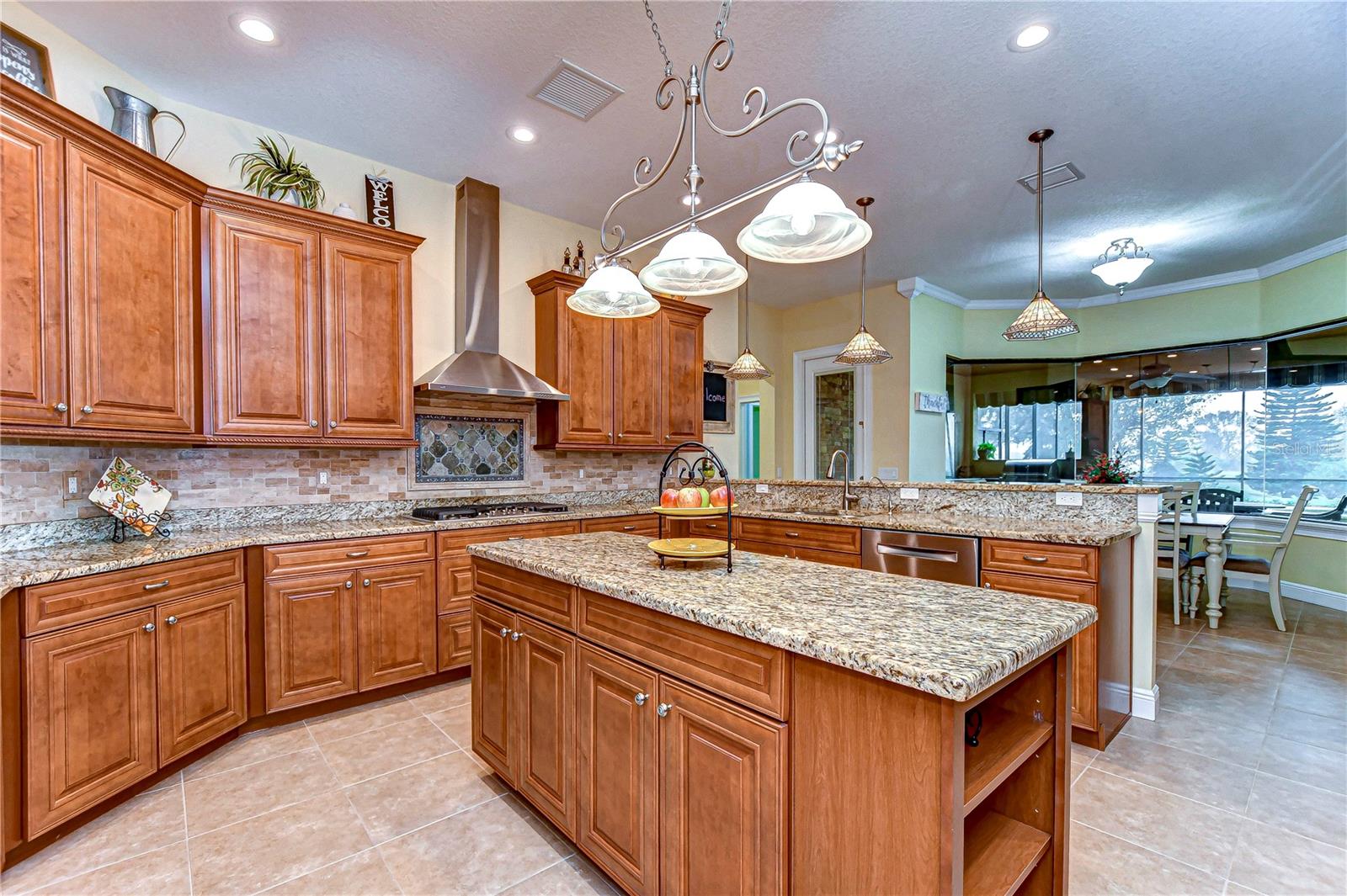 Hooded range and granite countertops elevate this kitchen!