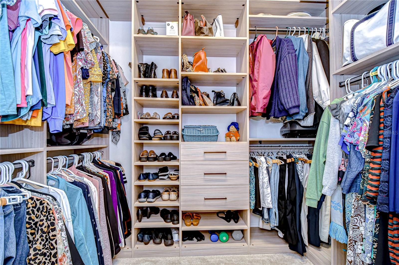 Walk in primary closet boasts beautiful built ins!