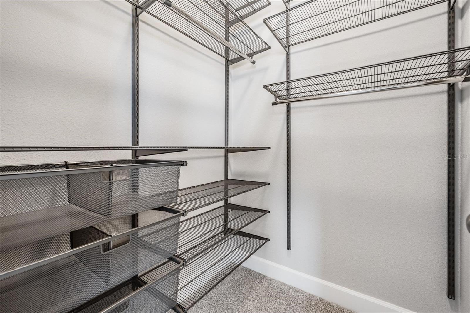 Walk-in closet with built-in storage solutions in bedroom #2