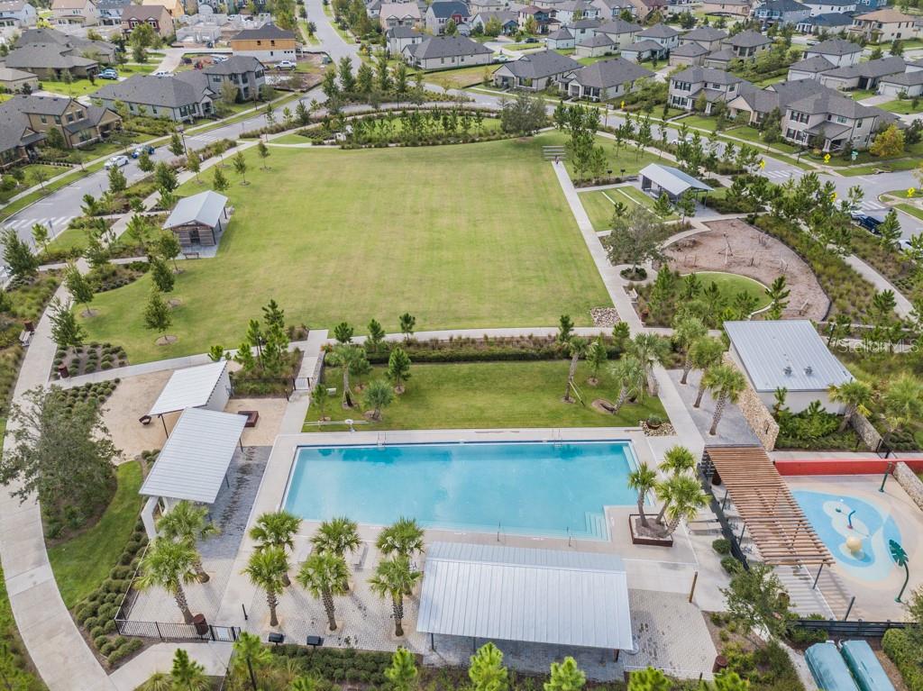 Whitfield Park: Community pool #1 with splash pad, open green space, fire pit, playground, and shelter with picnic tables