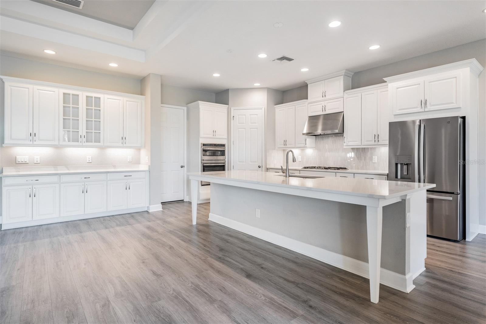 Added, extra cabinetry with glass front cabinets