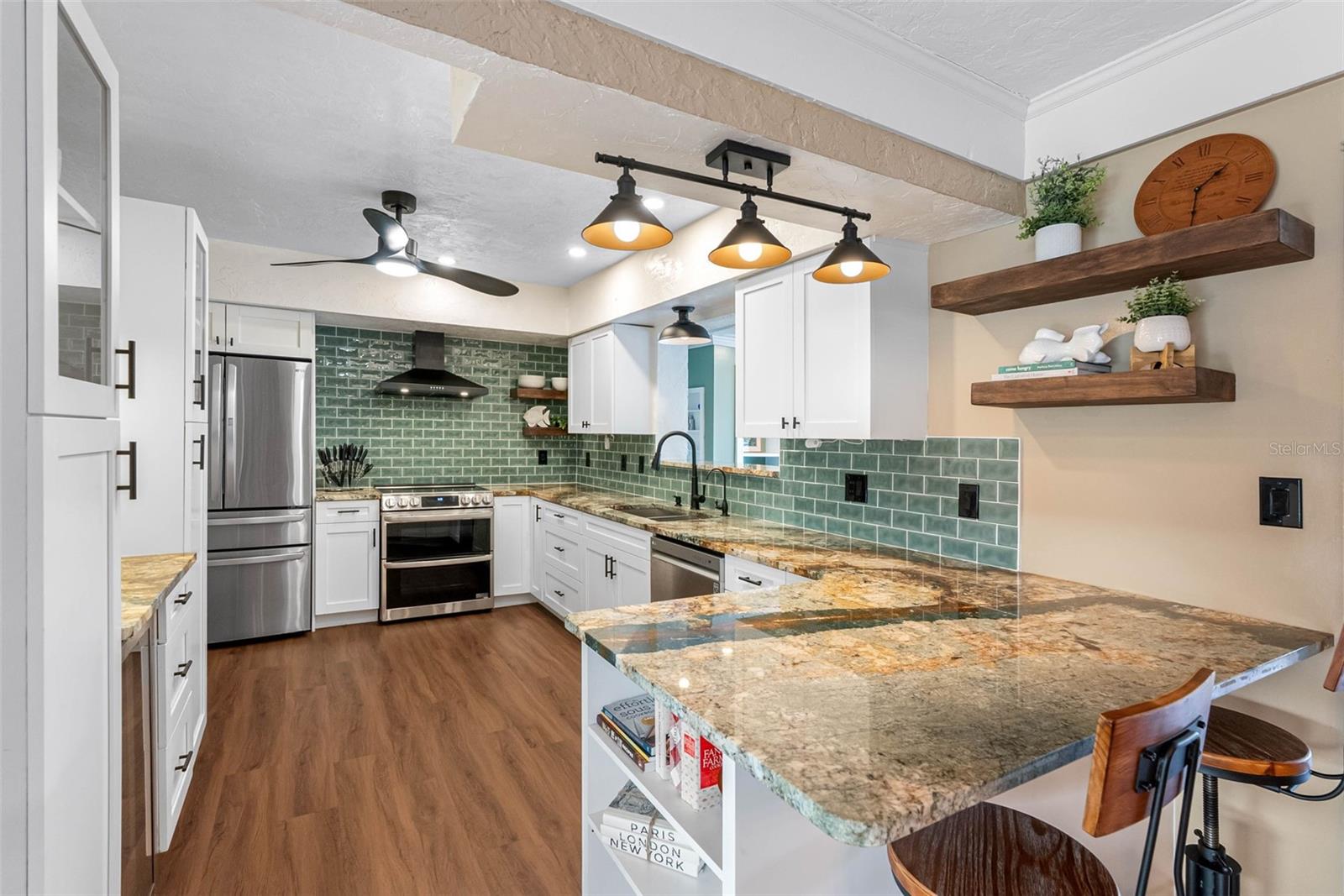 Luxurious Granite countertops, new appliances, and open shelving make this remodeled kitchen a standout.