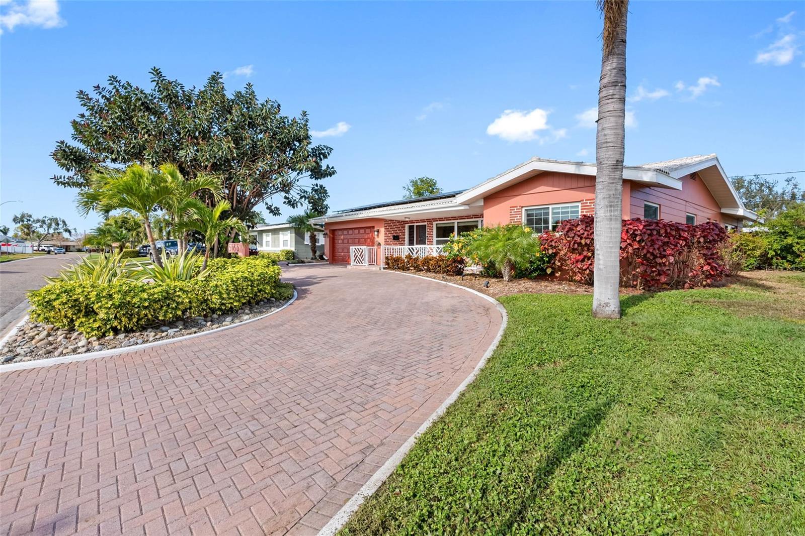 Royal palms and lush landscaping frame this beautifully maintained 4-bedroom pool home.