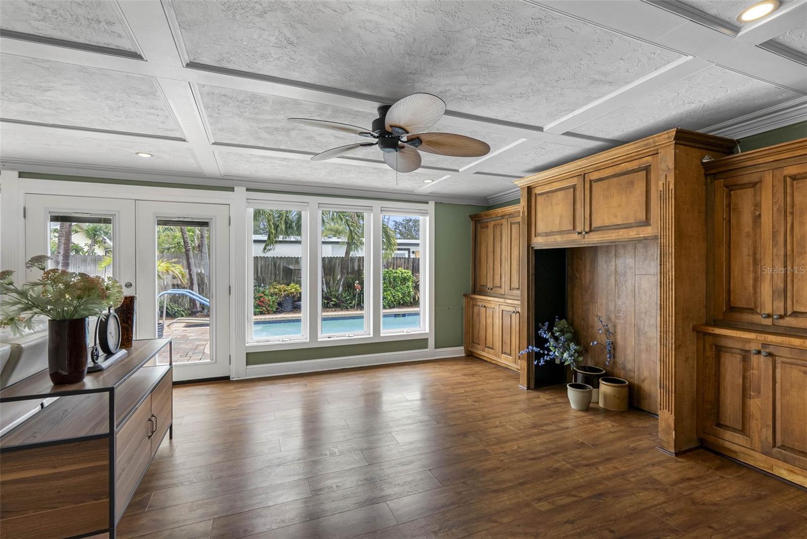 A wall of shelving in the family room provides ample storage and display space.