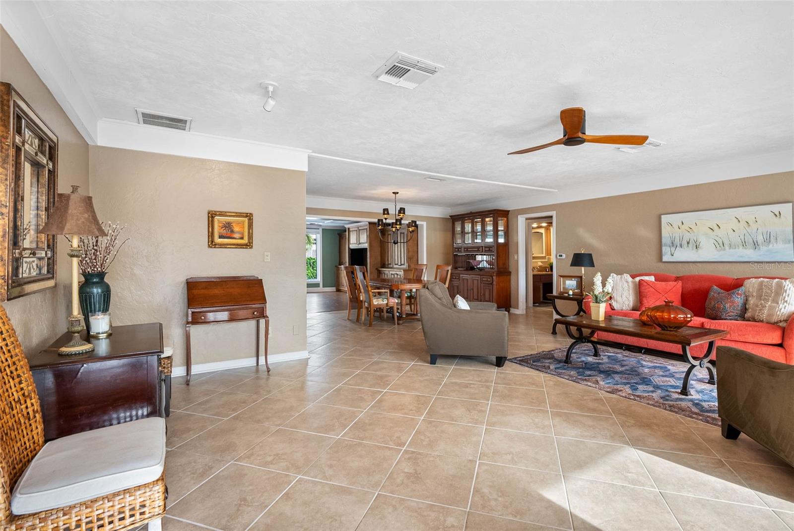 The open living room seamlessly flows into dining and family areas, ideal for entertaining.