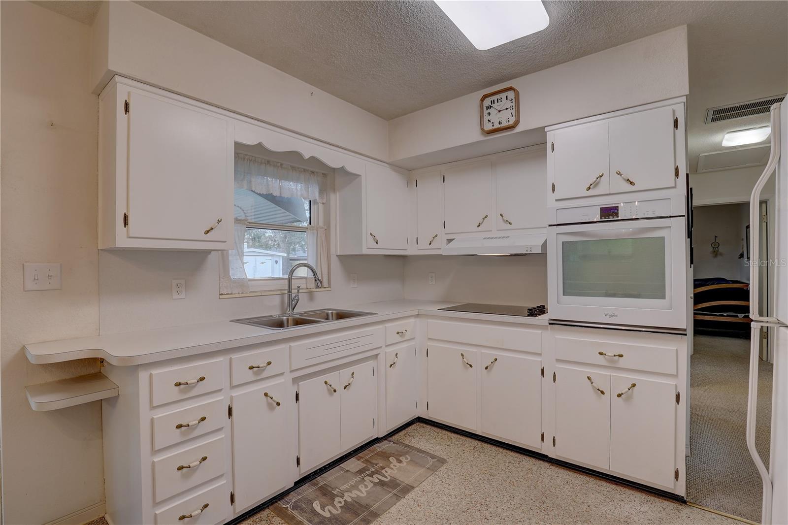 Neutral & functional kitchen with original solid wood cabinets