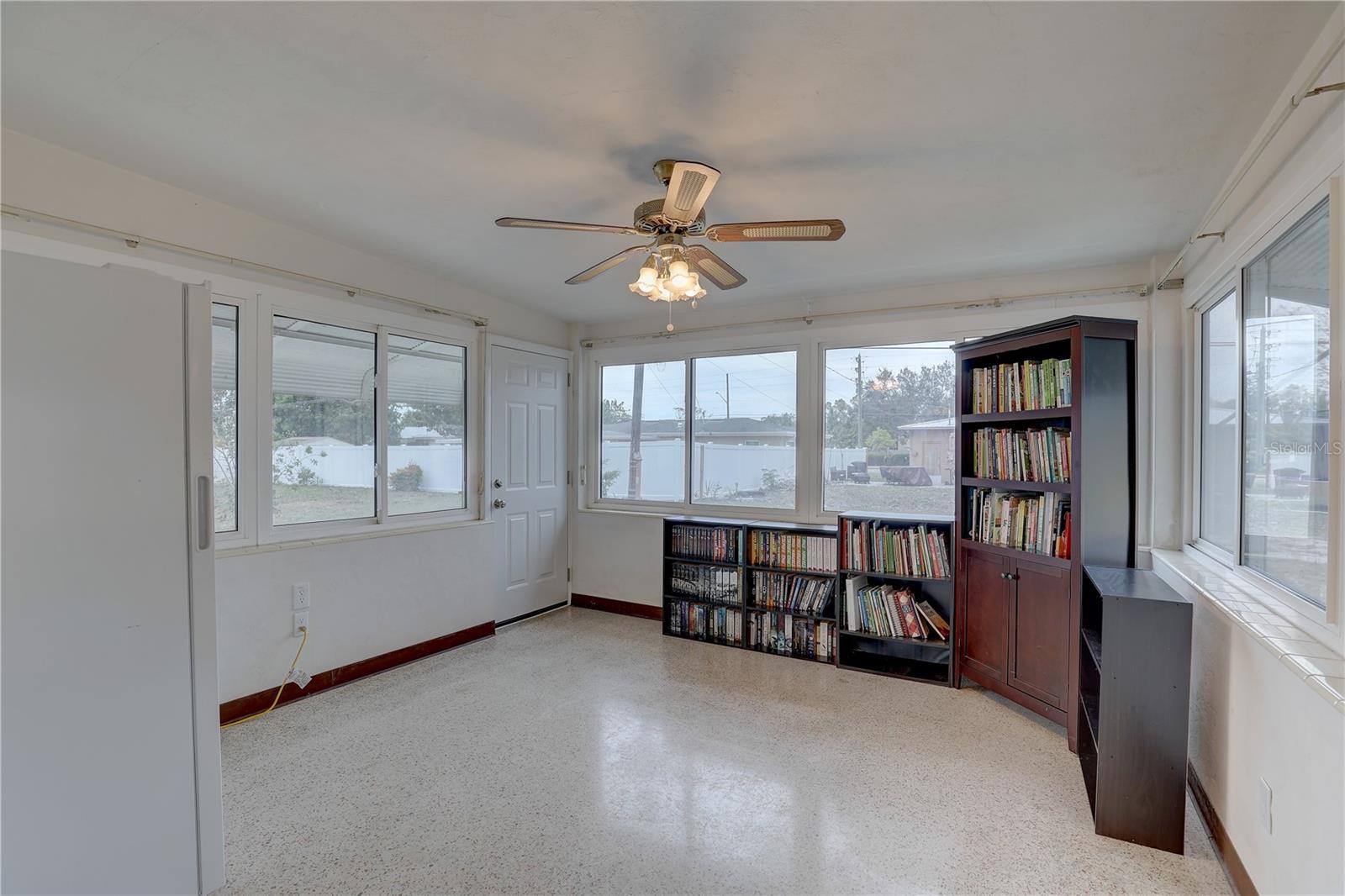 Florida Room off of the kitchen with wall to wall windows