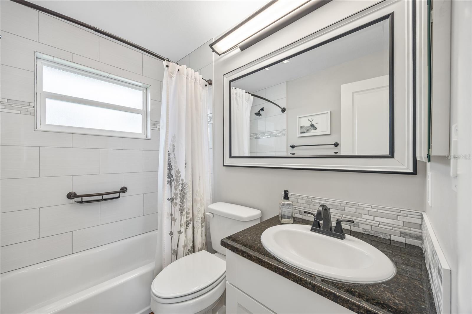 The bathroom is fully updated and is designed for efficiency, featuring beautiful subway tile in the shower/tub combination.