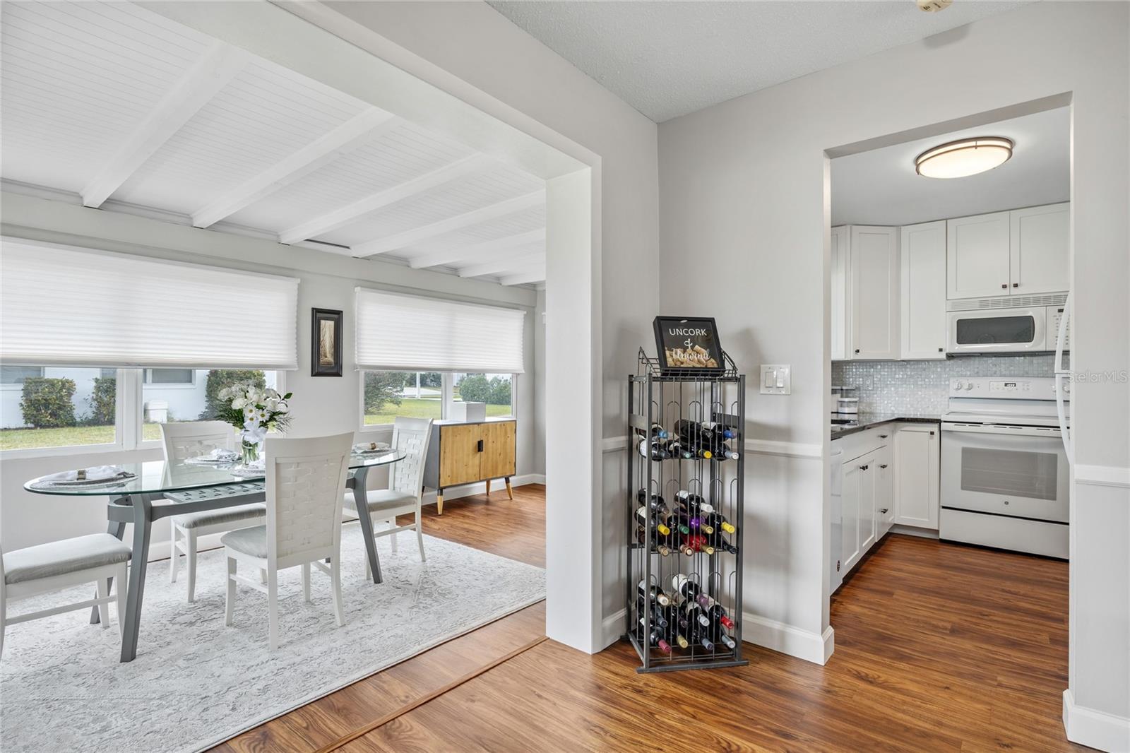 The Sunroom, Dining Room, and Kitchen are thoughtfully arranged to create a seamless space perfect for entertaining