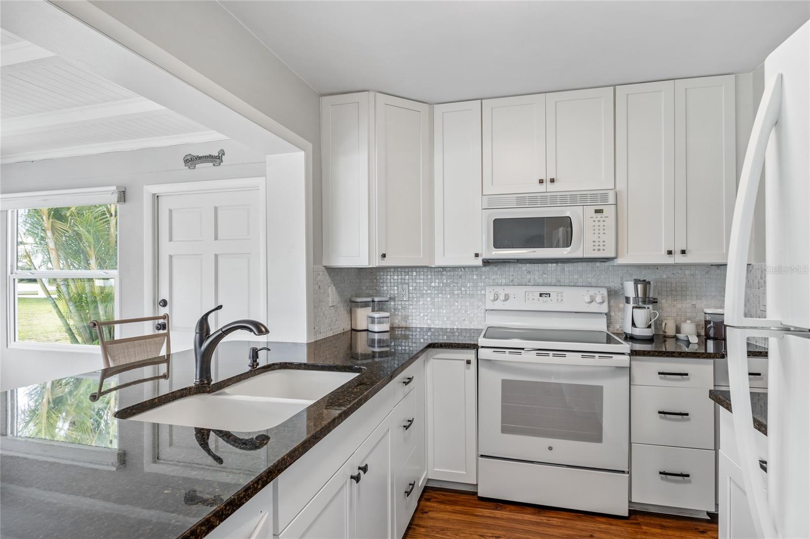 This kitchen is fully updated with beautiful granite counters, newer appliances and tall cabinets.