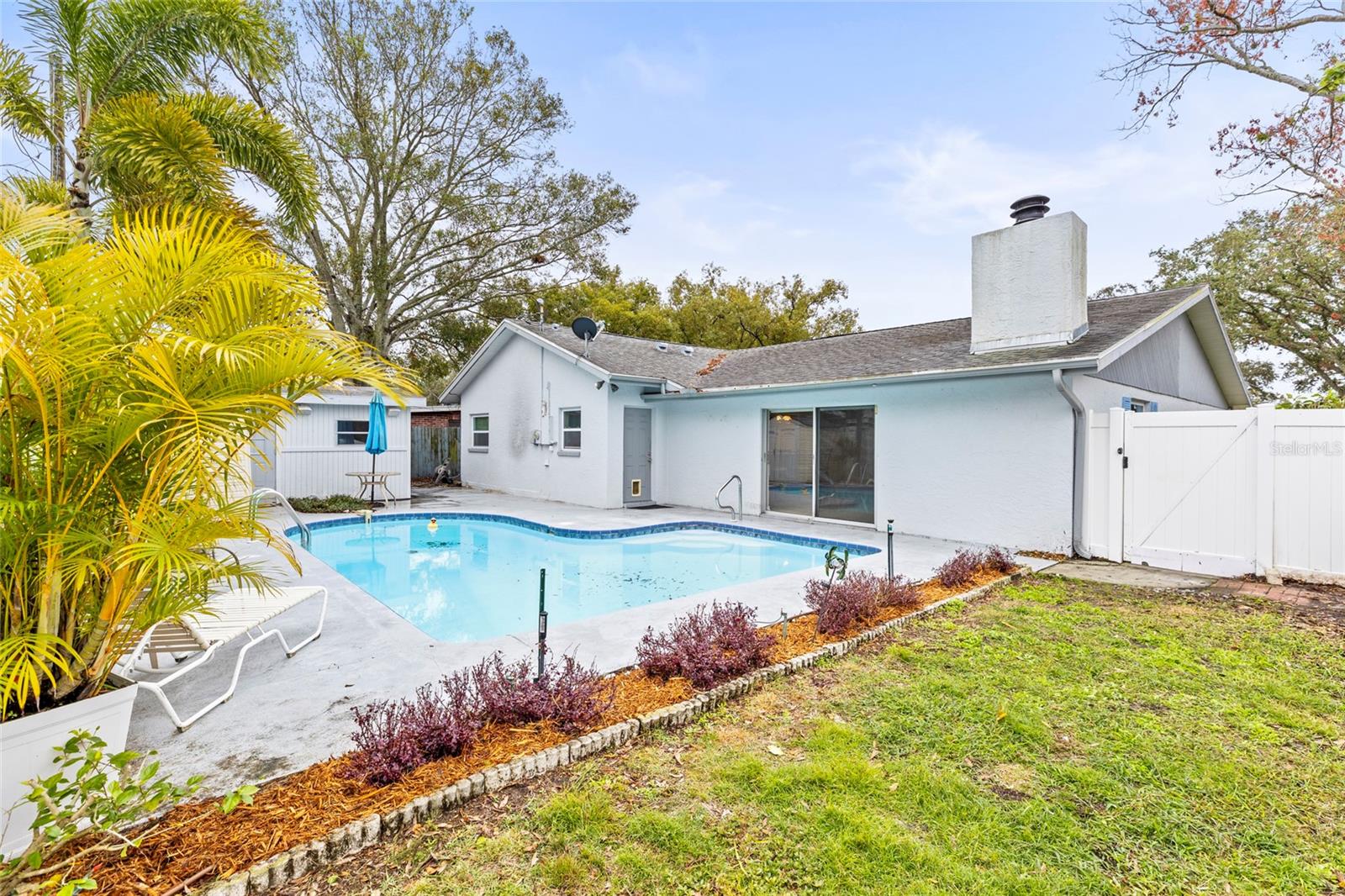 View of pool and backyard landscaping