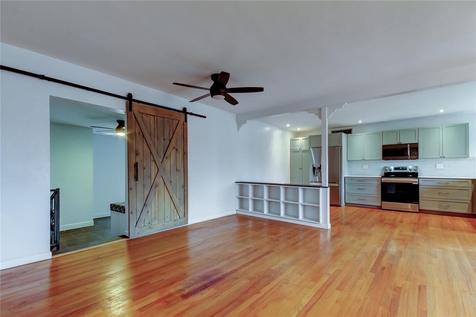 Barn door in Great Room has steps going down to the Bonus Room.