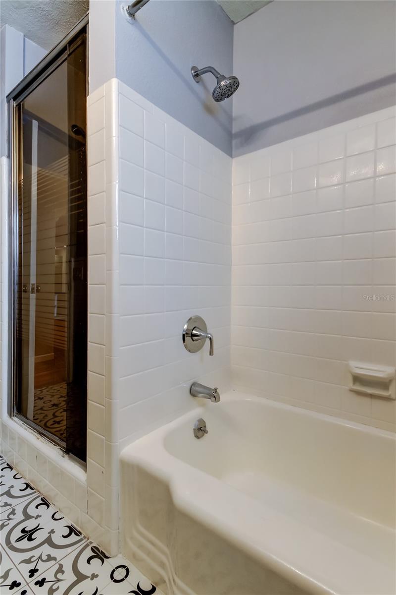 Separate shower to the left of the tub/shower