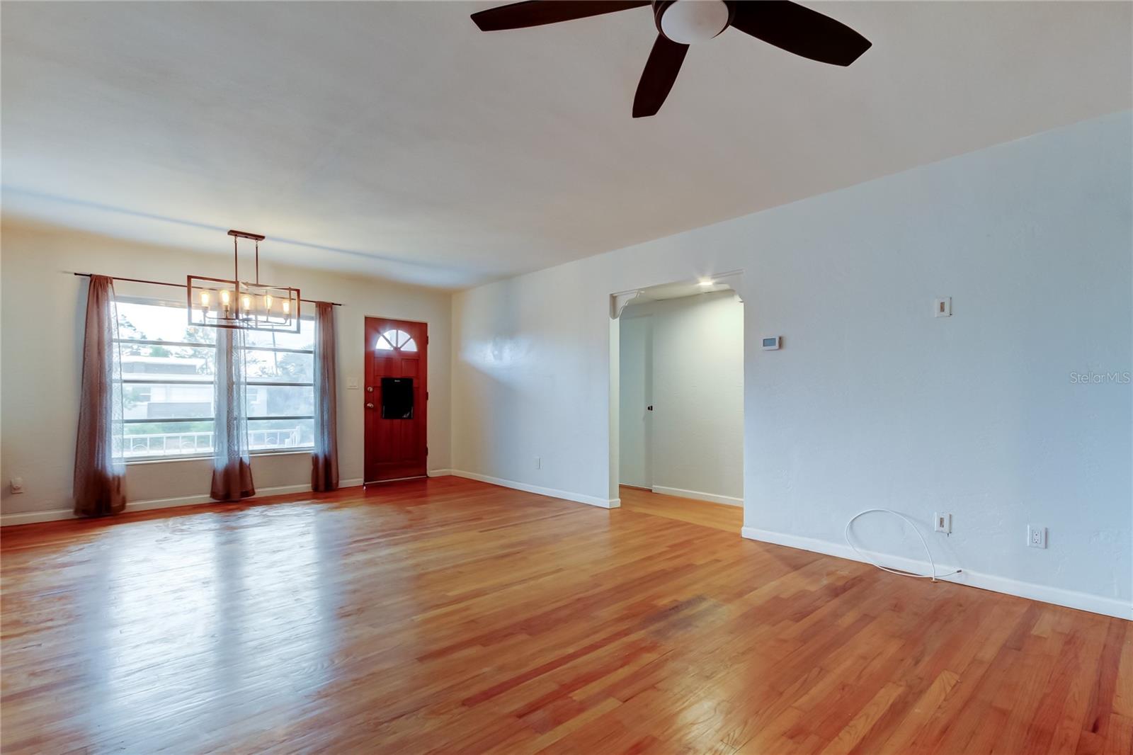 To the left of the front door as you enter is the hallway where the Laundry Room, Guest Bath, and Master Suite are located.