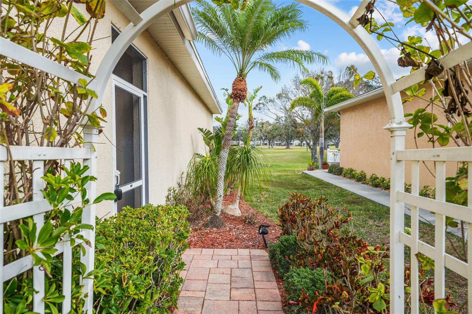 Through the rose trellis to the front door