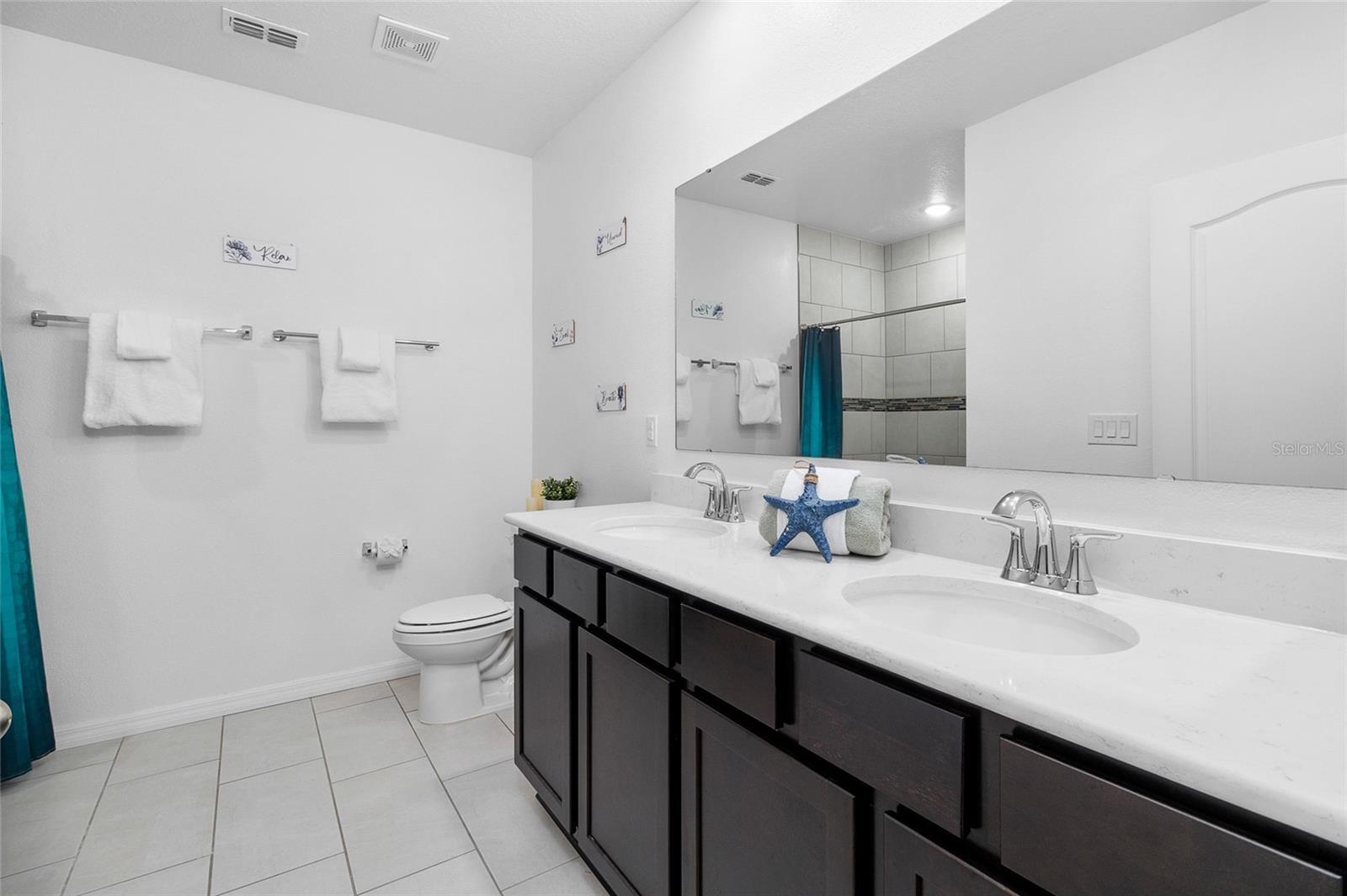 primary ensuite bathroom with solid surface Quartz vanity & walk-in shower