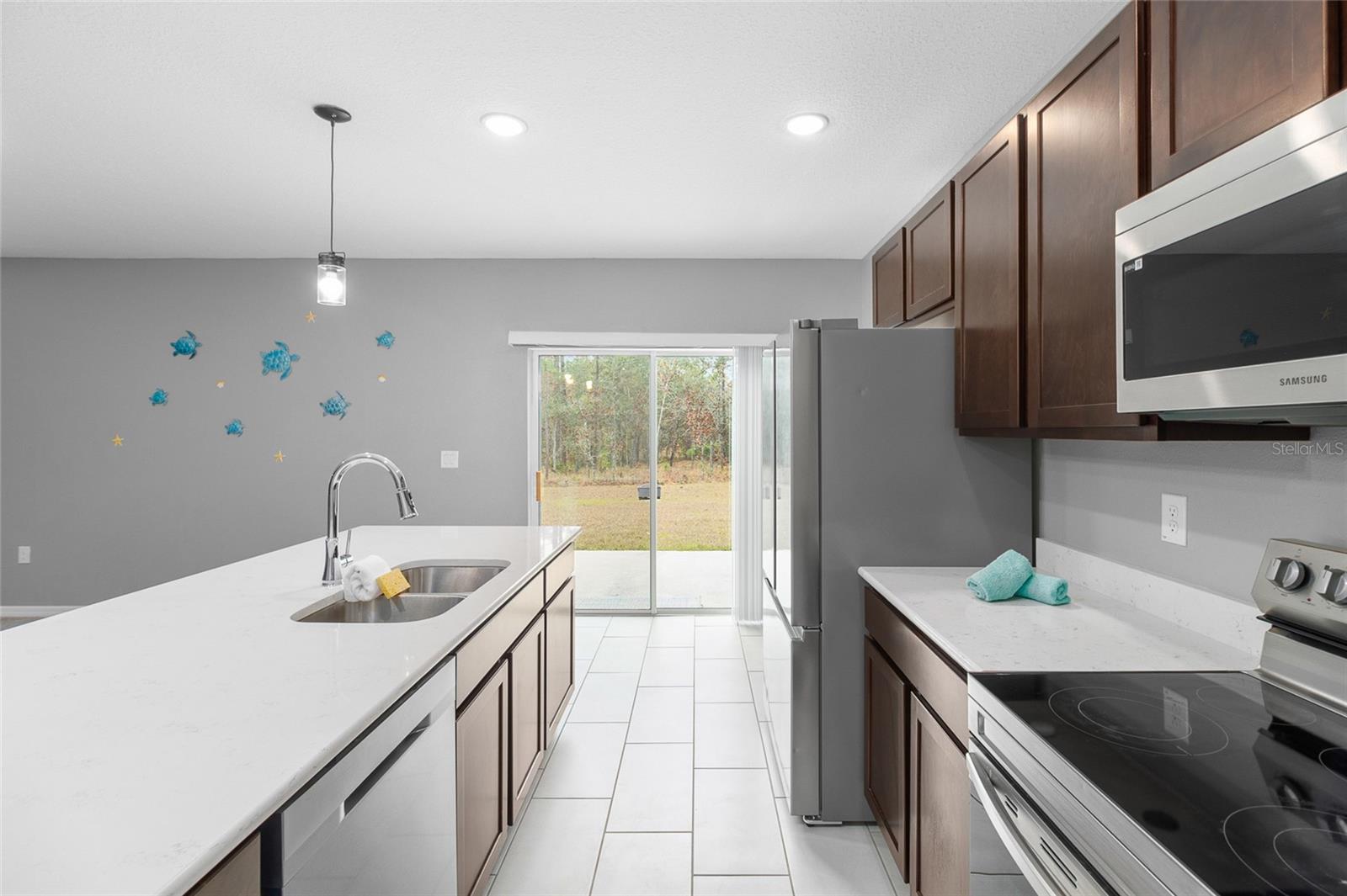 Gorgeous kitchen with gorgeous Quartz countertops, stainless  steel appliances