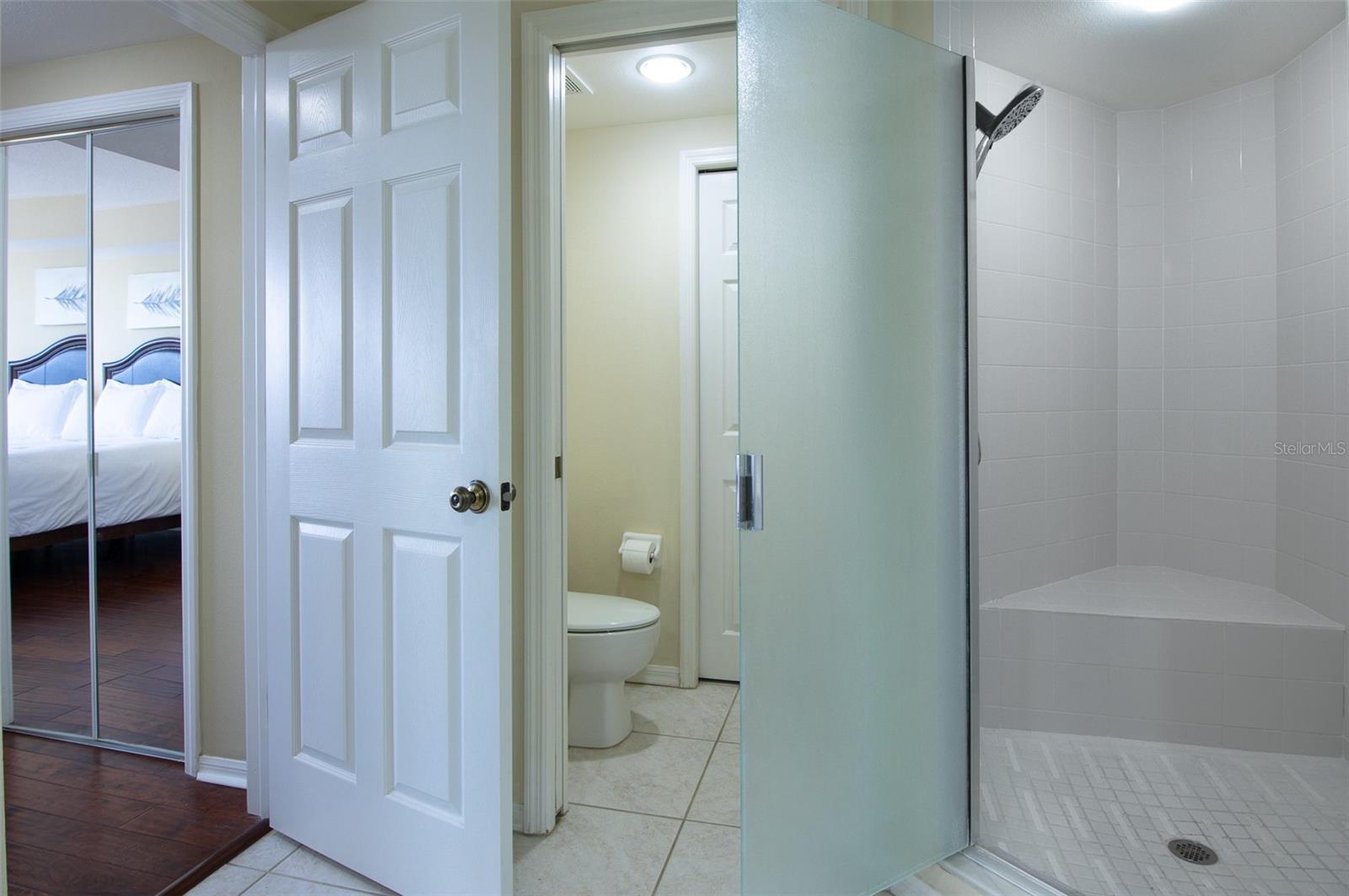 The door separates the primary bedroom from the ensuite bathroom!