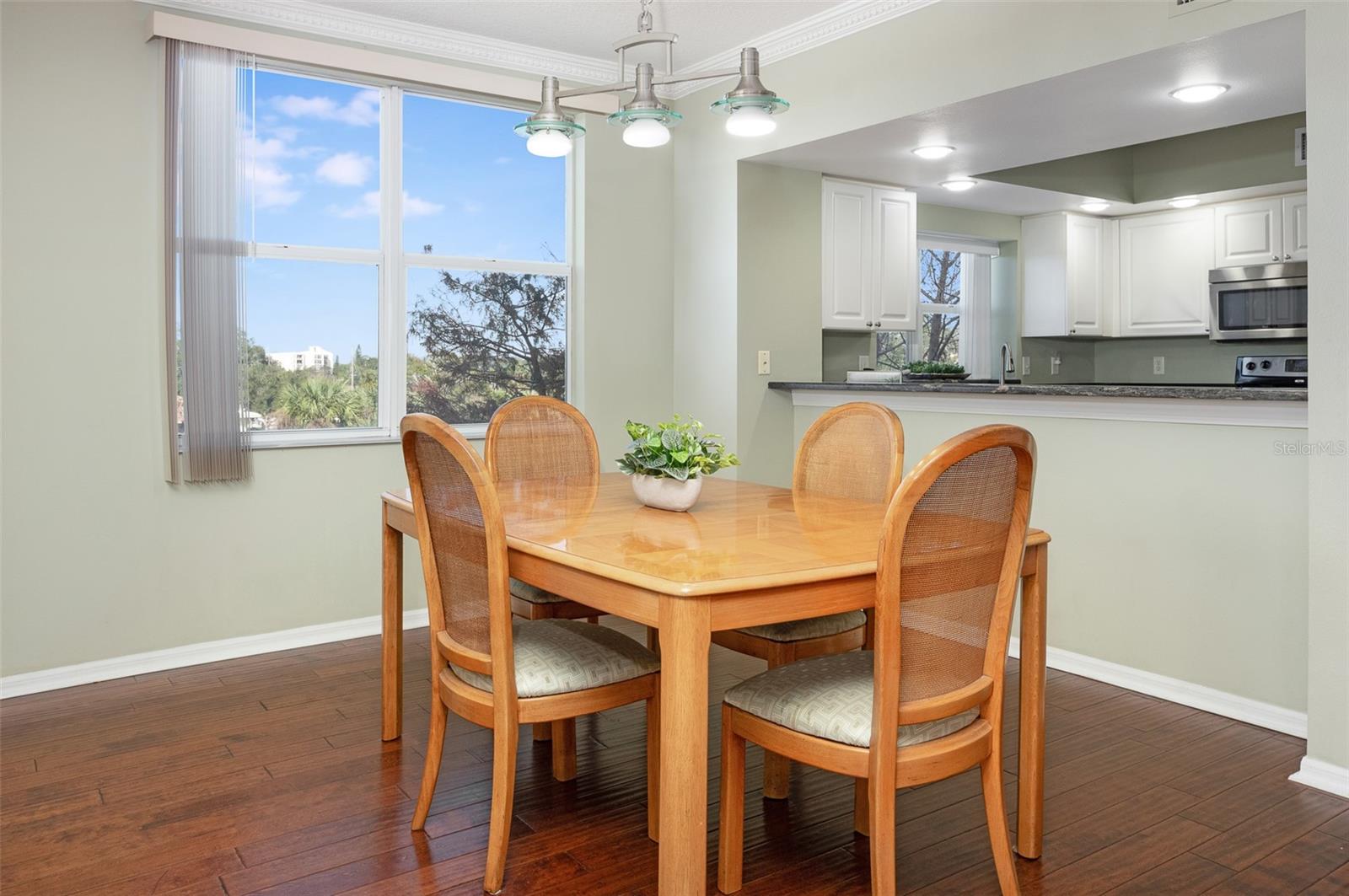 The dining area in the great room overlooking the kitchen with pass through