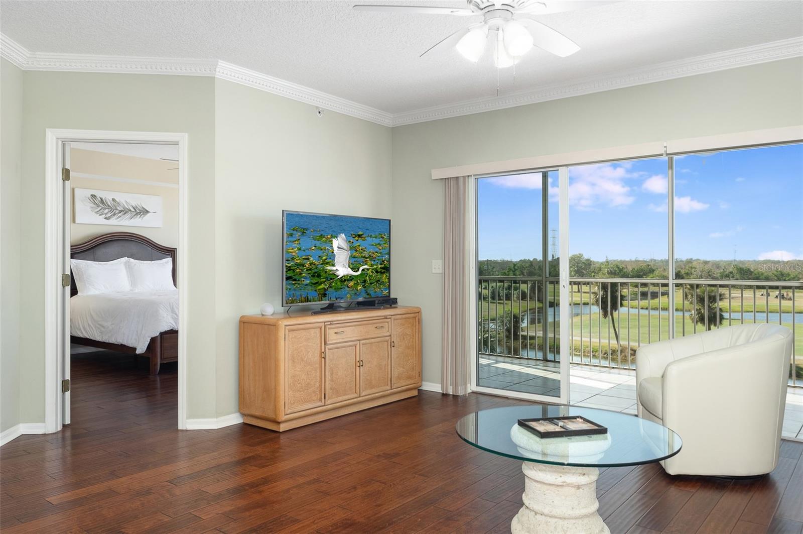 The primary bedroom suite is off of the living area! See the flowing engineer wood floors.