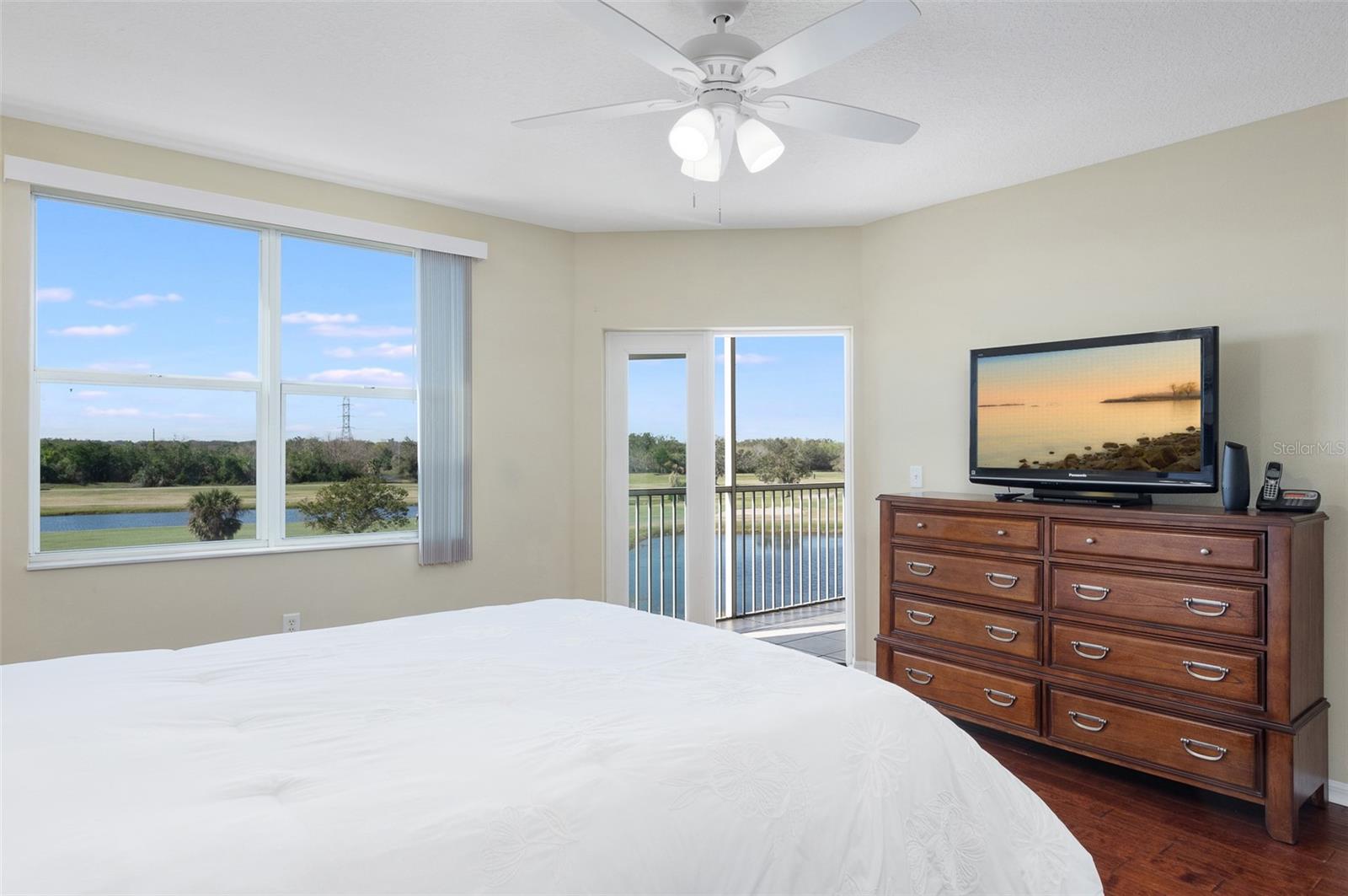 Wow, the Views from the primary suite! A door leads to the screen Florida room and balcony