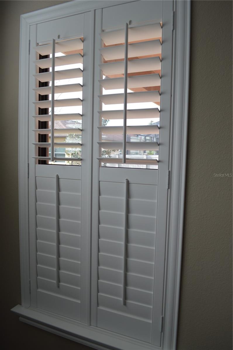 Wooden blinds in the master bedroom.