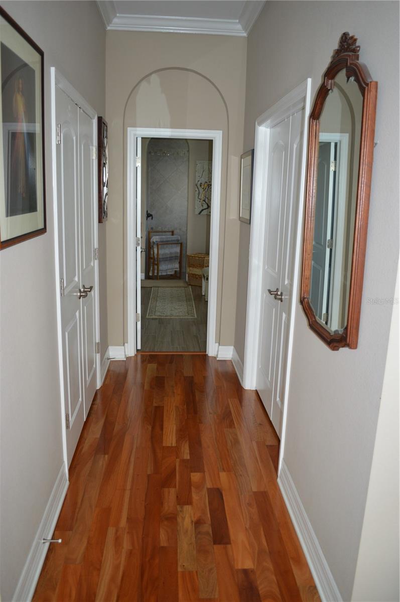 Hallway in the master bedroom toward the bath.  Walk in closets at each side.