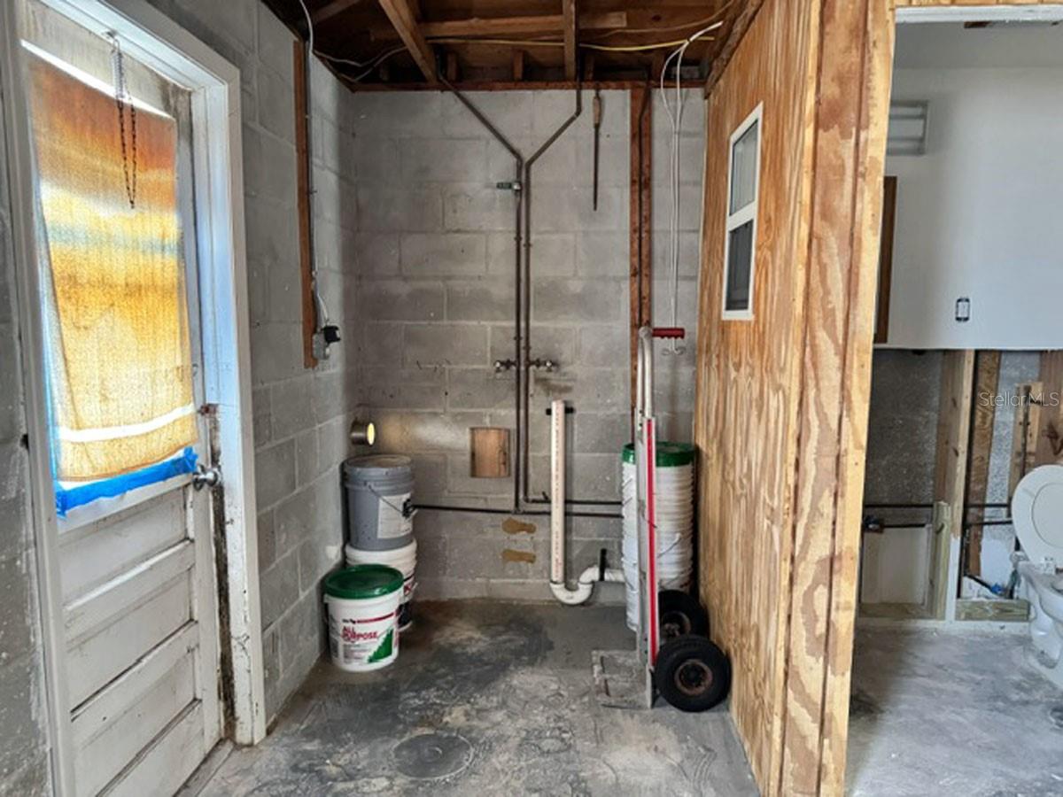 Laundry Room in garage next to a half bath