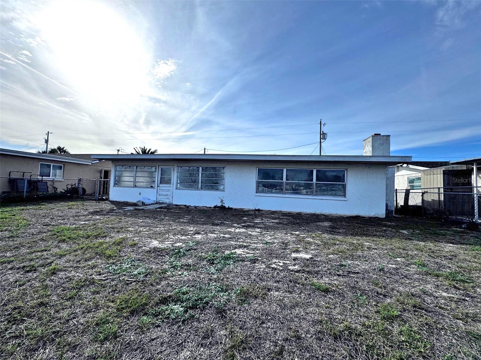 Rear of house with door from Florida Room to fenced back yard.