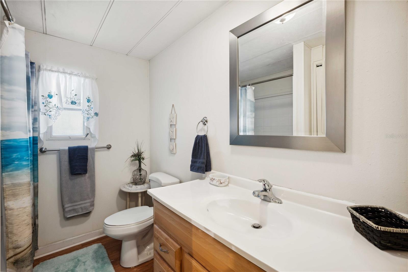 Guest bath with updated tub, surround and vanity