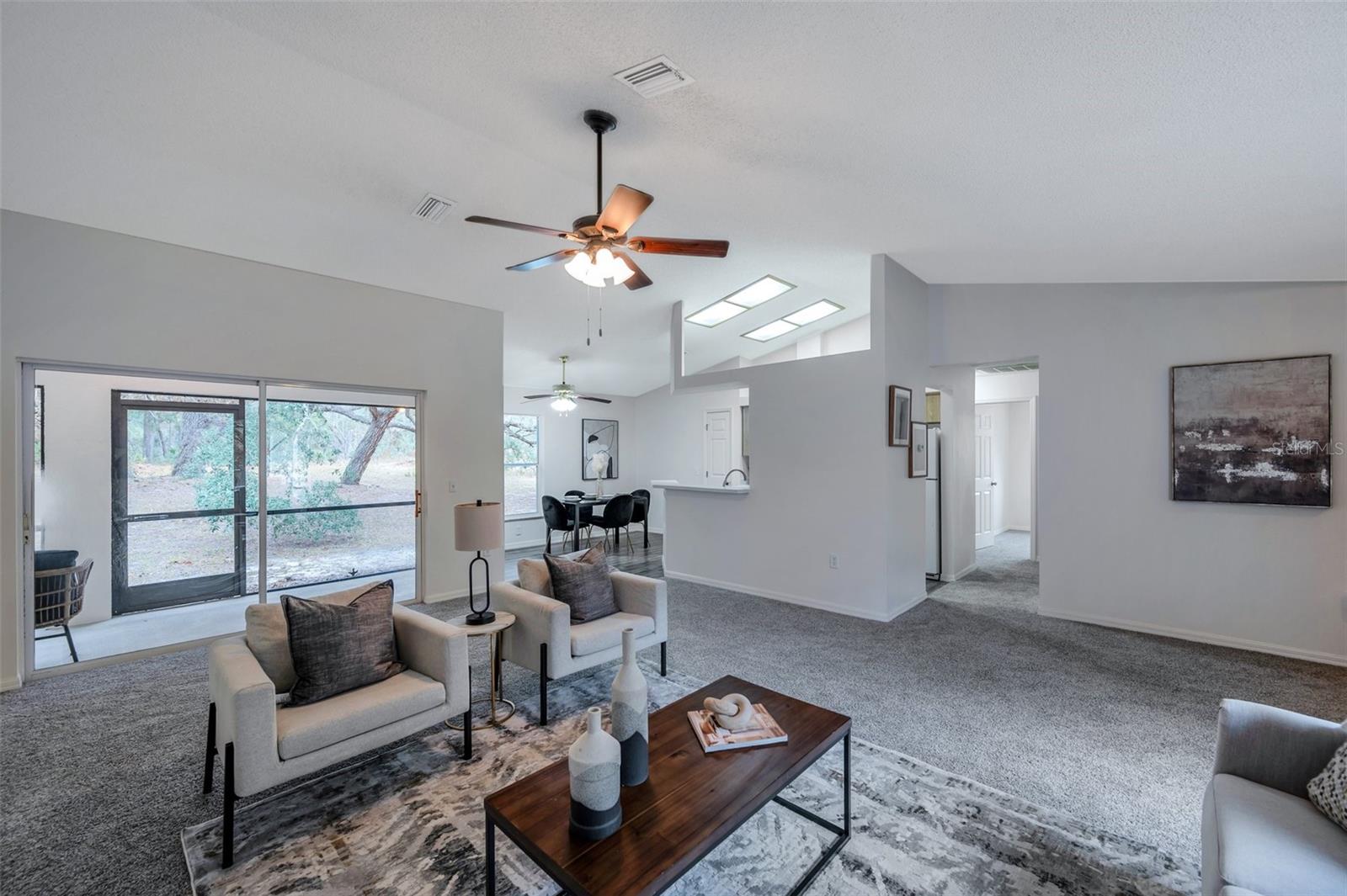 Living Room with sliders to a large, screened Lanai.