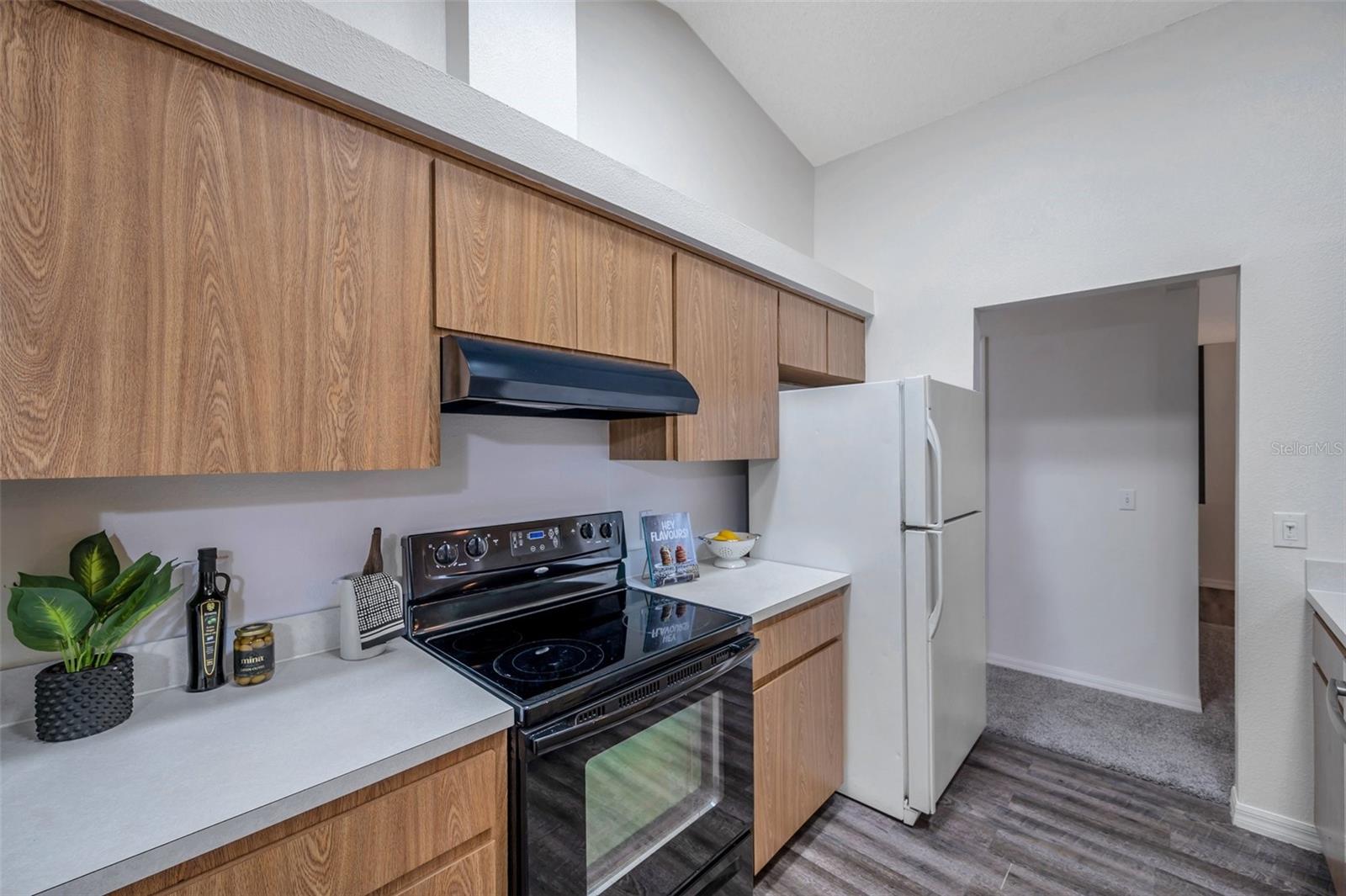 Kitchen passes through to hall to Laundry Room, 2nd and 3rd Bedrooms.