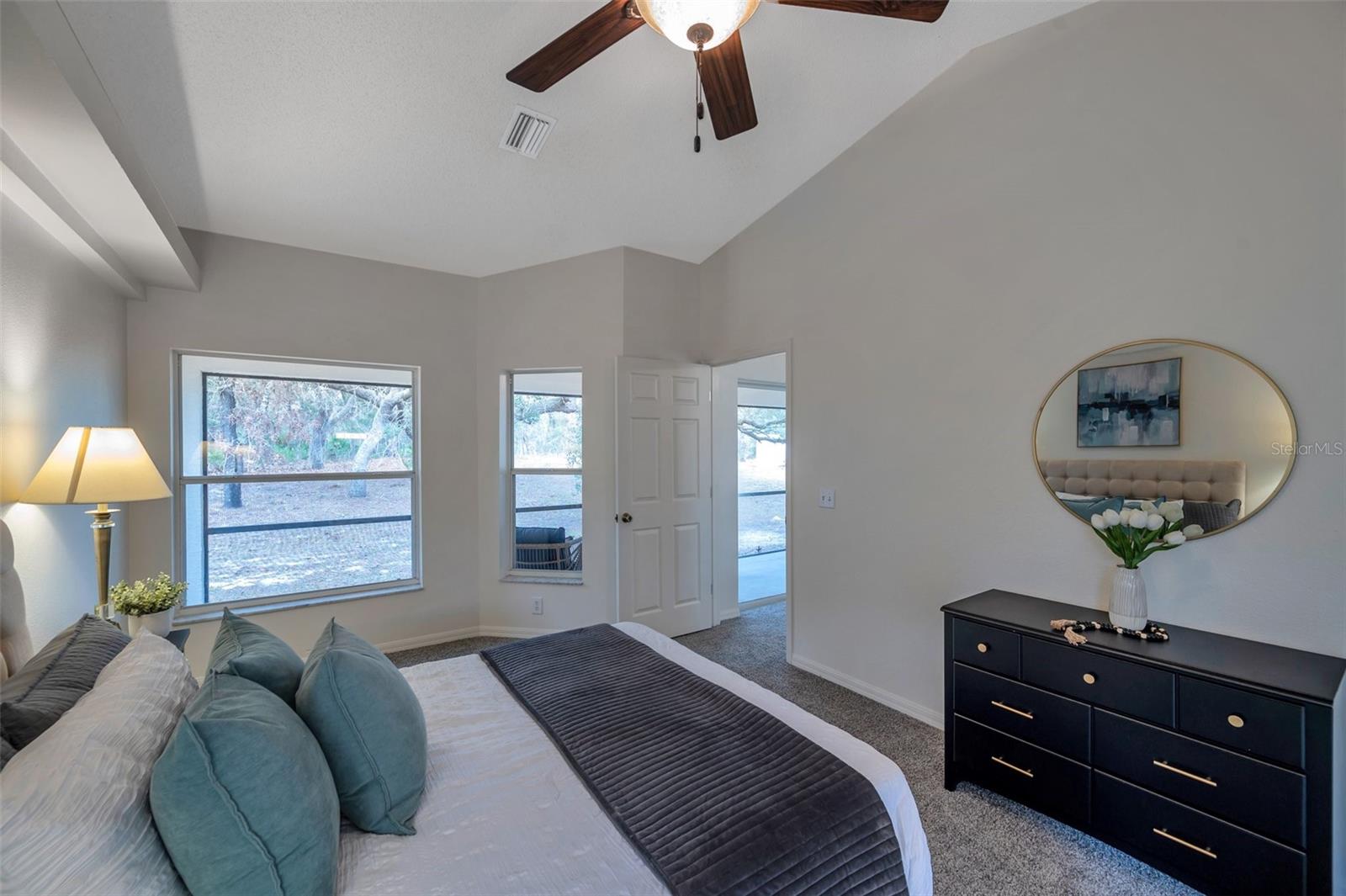 Looking from Primary Suite, with plenty of natural light, toward backyard and door to Living Room.