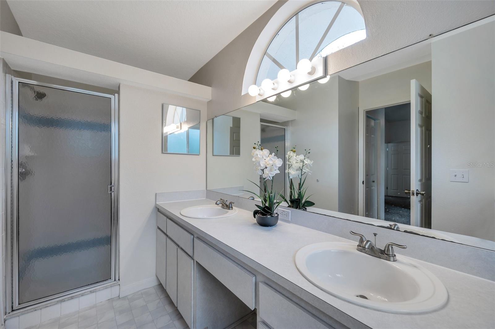 En-suite Bathroom with dual vanities and walk-in shower.