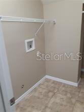 Laundry room with extra storage under the stairs