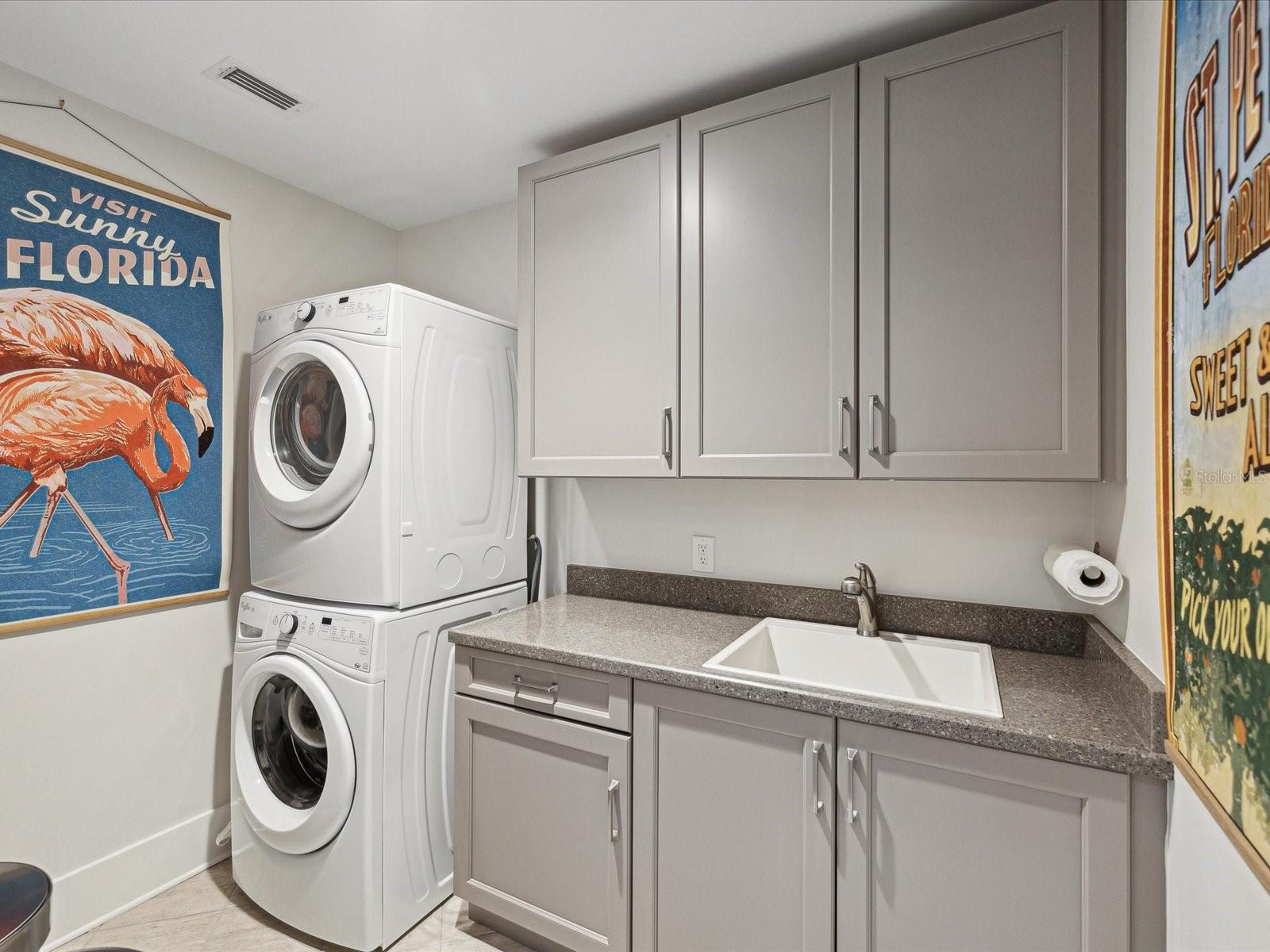 Laundry Room with cabinetry and sink