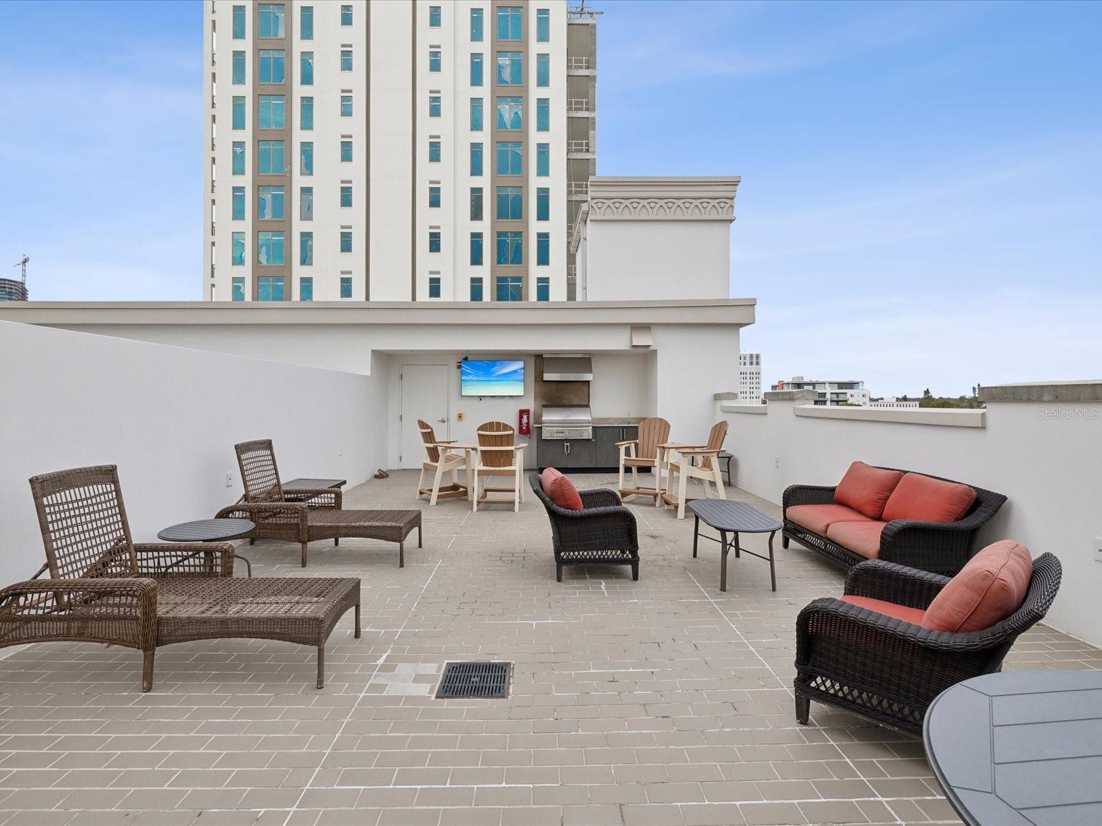 Rooftop entertaining area for residents with TV and Gas Grill